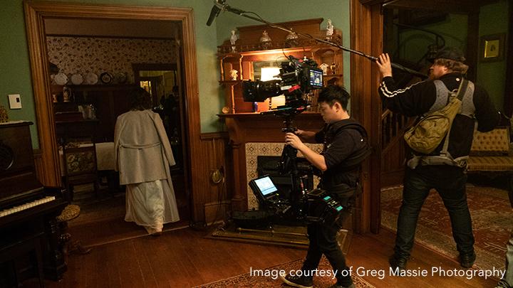 woman walking with camera men