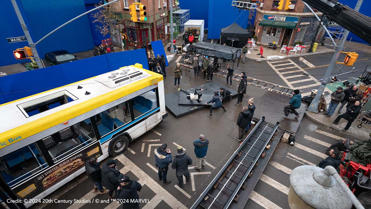 Behind the scenes on The Oner city street shot showing blue screens for set extensions